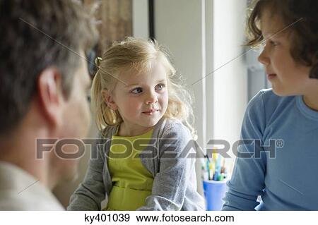 Stock Photo - Man with his children at home. Fotosearch