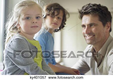 Stock Photo - Man with their children at home. Fotosearch