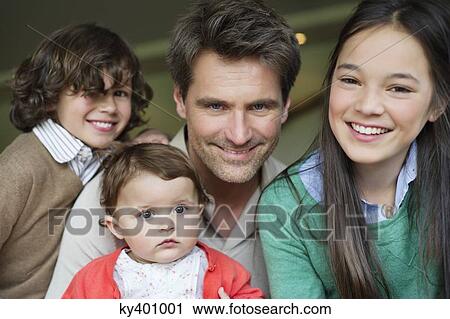 Portrait of a happy man with their children smiling View Large Photo Image Stock Image - Portrait of a happy man with their children smiling. Fotosearch