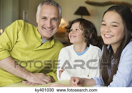 Stock Image - Portrait of a man with his children smiling. Fotosearch