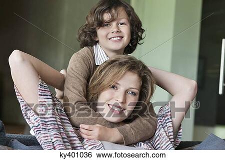 Stock Photograph - Portrait of a woman smiling with her son. Fotosearch