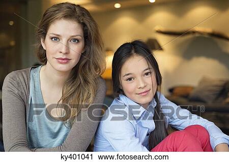Portrait of a woman smiling with her daughter View Large Photo Image Stock Image - Portrait of a woman smiling with her daughter. Fotosearch
