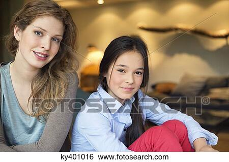 Portrait of a woman smiling with her daughter View Large Photo Image Stock Photograph - Portrait of a woman smiling with her daughter. Fotosearch