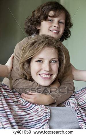 Stock Photo - Portrait of a woman smiling with his son. Fotosearch