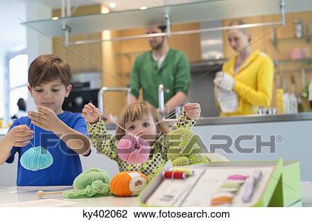 Boy and his sister playing with woolen balls View Large Photo Image Stock Image - Boy and his sister playing with woolen balls. Fotosearch