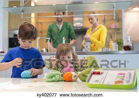 Boy and his sister playing with woolen balls View Large Photo Image Stock Photo - Boy and his sister playing with woolen balls. Fotosearch