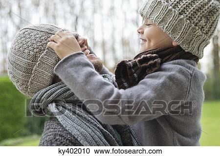 Boy playing with his father's cap View Large Photo Image Stock Image - Boy playing with his father's cap. Fotosearch