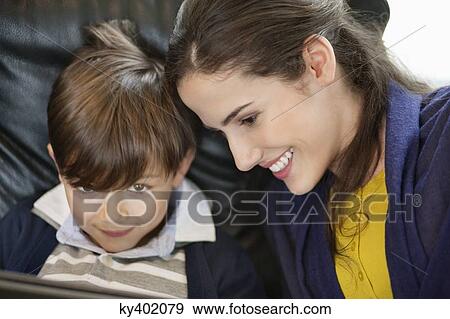Close-up of a woman with her son View Large Photo Image Stock Photo - Close-up of a woman with her son. Fotosearch