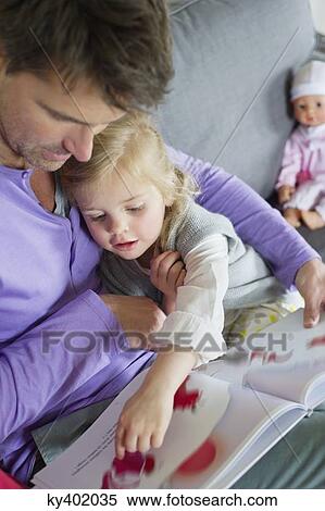 Girl studying with her father at home View Large Photo Image Stock Photography - Girl studying with her father at home. Fotosearch