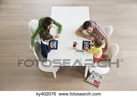 High angle view of couple teaching their children View Large Photo Image Stock Photograph - High angle view of couple teaching their children. Fotosearch