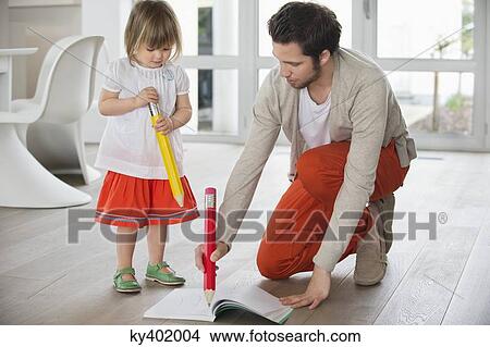 Man and daughter writing with big pencils View Large Photo Image Picture - Man and daughter writing with big pencils. Fotosearch