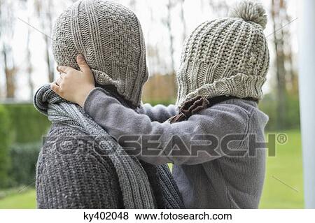 Man and son covering their faces with hats View Large Photo Image Stock Photo - Man and son covering their faces with hats. Fotosearch