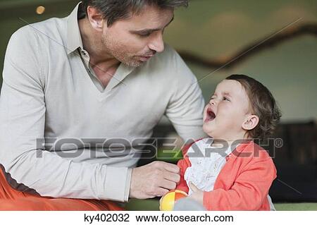 Man consoling his crying daughter View Large Photo Image Stock Image - Man consoling his crying daughter. Fotosearch