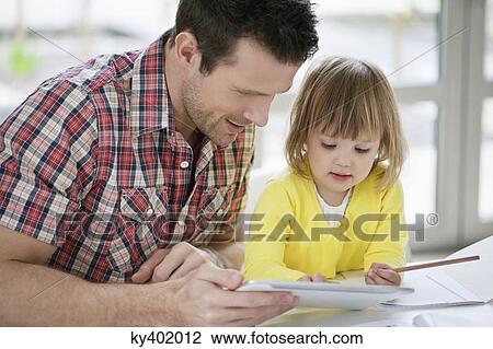 Stock Image - Man teaching his daughter. Fotosearch