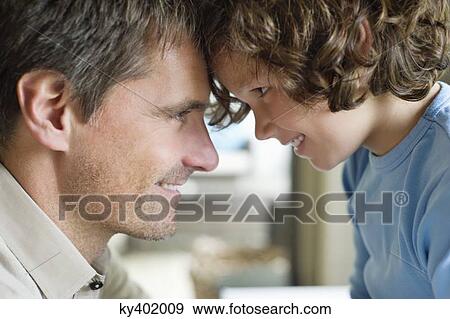 Stock Photo - Man with his son face to face and smiling. Fotosearch