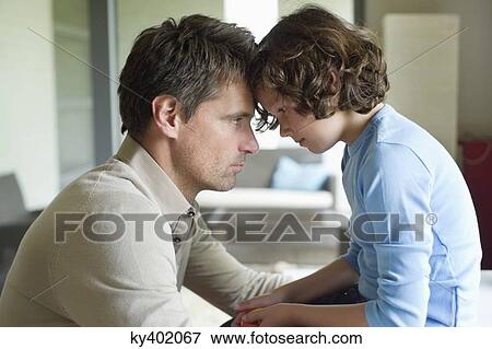 Stock Photo - Man with his son face to face and looking serious. Fotosearch