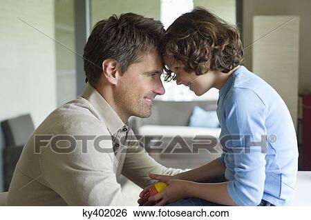 Man with his son face to face and smiling View Large Photo Image Stock Photograph - Man with his son face to face and smiling. Fotosearch