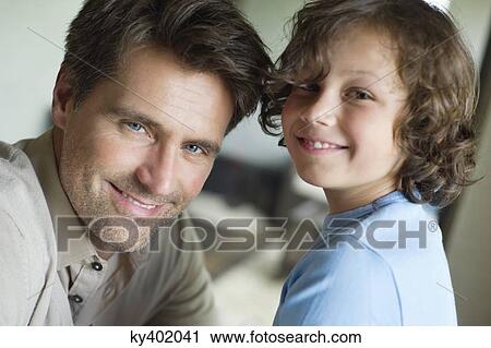 Portrait of a man with his son smiling View Large Photo Image Stock Image - Portrait of a man with his son smiling. Fotosearch