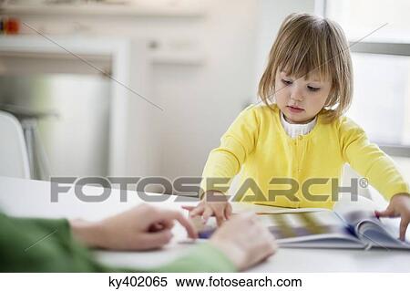 Woman teaching her daughter at home View Large Photo Image Stock Photography - Woman teaching her daughter at home. Fotosearch
