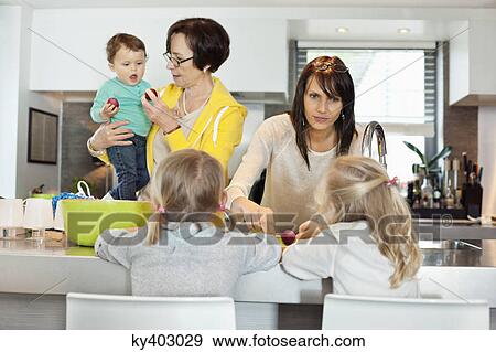 Girls with her mother and grandmother in a kitchen View Large Photo Image Stock Photo - Girls with her mother and grandmother in a kitchen. Fotosearch