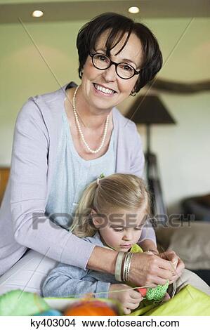 Little girl learning knitting from her grandmother View Large Photo Image Picture - Little girl learning knitting from her grandmother. Fotosearch