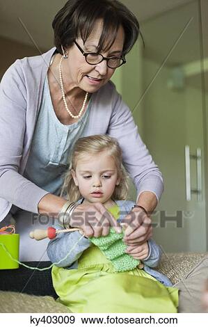 Little girl learning knitting from her grandmother View Large Photo Image Stock Photo - Little girl learning knitting from her grandmother. Fotosearch