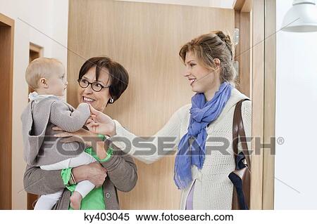 Stock Photography - Woman loving her daughter at home arrival. Fotosearch