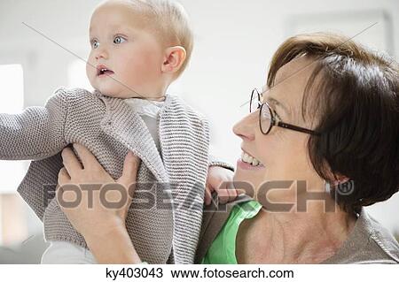 Stock Image - Woman playing with her granddaughter. Fotosearch