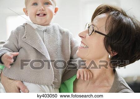 Woman playing with her granddaughter View Large Photo Image Stock Image - Woman playing with her granddaughter. Fotosearch