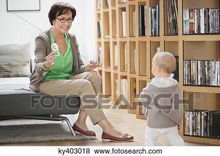 Stock Photo - Woman playing with her granddaughter. Fotosearch