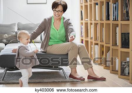 Stock Photograph - Woman playing with her granddaughter. Fotosearch