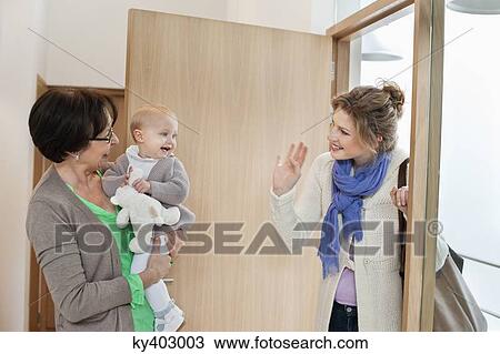 Stock Image - Woman waving to her daughter. Fotosearch
