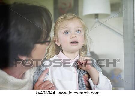 Woman with her granddaughter near a window View Large Photo Image Picture - Woman with her granddaughter near a window. Fotosearch