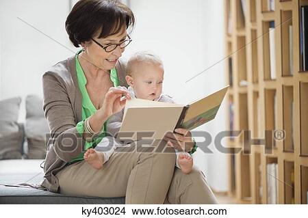 Woman with her granddaughter reading a picture book View Large Photo Image Picture - Woman with her granddaughter reading a picture book. Fotosearch