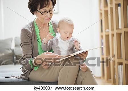 Woman with her granddaughter reading a picture book View Large Photo Image Stock Photo - Woman with her granddaughter reading a picture book. Fotosearch