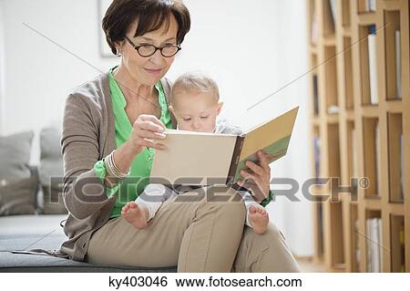 Woman with her granddaughter reading a picture book View Large Photo Image Stock Photograph - Woman with her granddaughter reading a picture book. Fotosearch