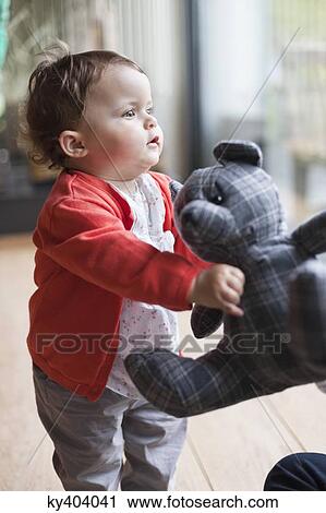 Baby girl holding a teddy bear View Large Photo Image Stock Image - Baby girl holding a teddy bear. Fotosearch