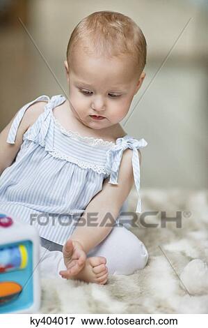 Baby girl playing with a musical block toy View Large Photo Image Stock Photo - Baby girl playing with a musical block toy. Fotosearch