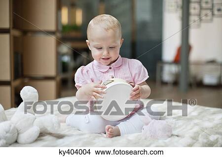 Baby girl playing with a tambourine View Large Photo Image Picture - Baby girl playing with a tambourine. Fotosearch