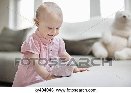 Baby girl playing with a toy View Large Photo Image Stock Image - Baby girl playing with a toy. Fotosearch