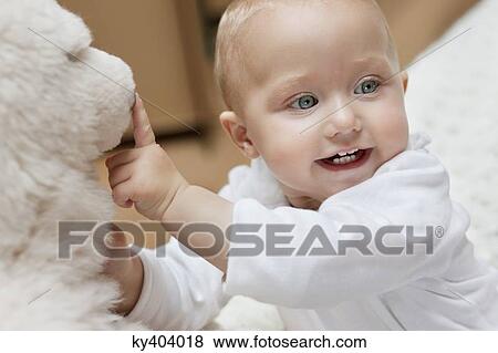 Baby girl playing with a toy View Large Photo Image Stock Photo - Baby girl playing with a toy. Fotosearch
