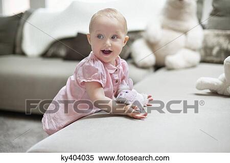 Baby girl playing with a toy View Large Photo Image Stock Photography - Baby girl playing with a toy. Fotosearch