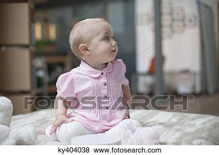 Baby girl sitting with toys View Large Photo Image Stock Photo - Baby girl sitting with toys. Fotosearch