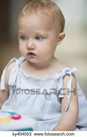 Baby girl with a musical block toy View Large Photo Image Stock Image - Baby girl with a musical block toy. Fotosearch
