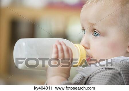 Close-up of a baby girl feeding milk View Large Photo Image Stock Image - Close-up of a baby girl feeding milk. Fotosearch