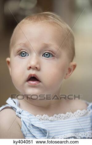 Close-up of a baby girl looking away View Large Photo Image Stock Image - Close-up of a baby girl looking away. Fotosearch