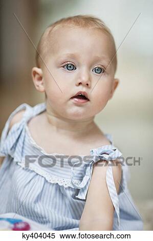 Close-up of a baby girl looking away View Large Photo Image Stock Photography - Close-up of a baby girl looking away. Fotosearch