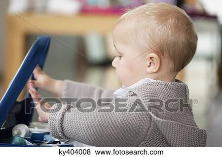 Close-up of a baby girl playing View Large Photo Image Stock Photo - Close-up of a baby girl playing. Fotosearch
