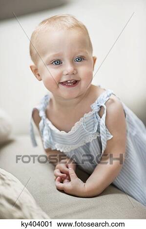 Stock Image - Close-up of a baby girl smiling. Fotosearch