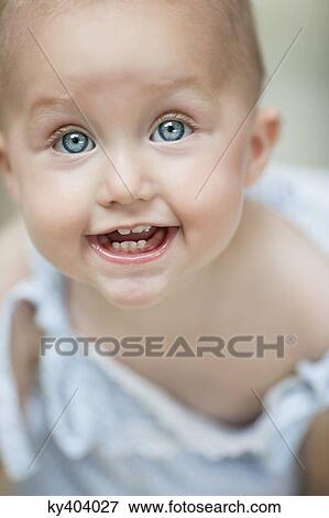Stock Photo - Close-up of a baby girl smiling. Fotosearch
